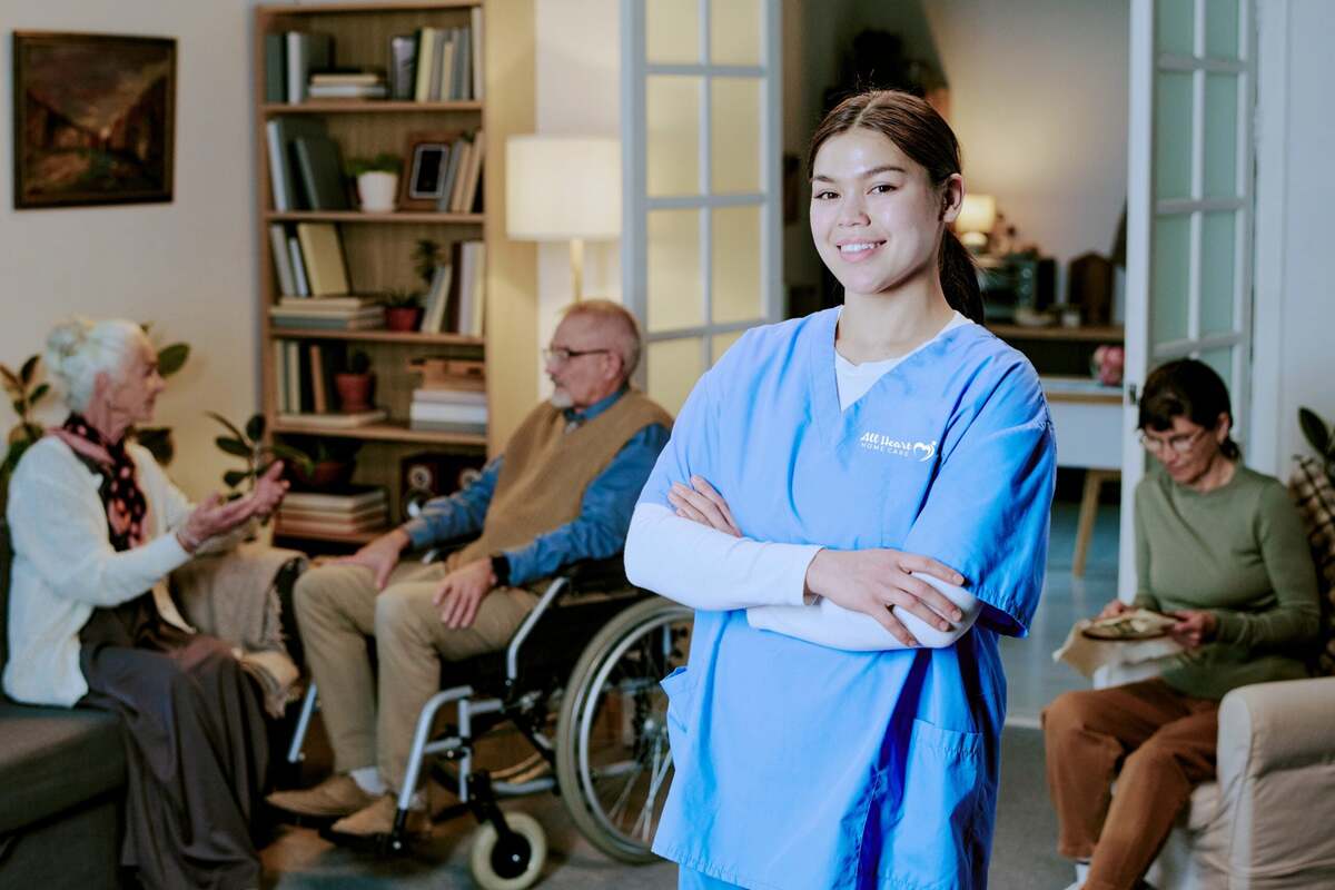 Family caregiver receiving relief while professional caregiver helps elderly person